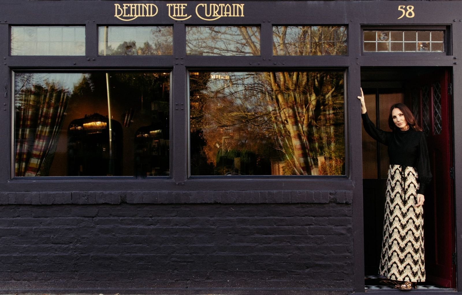 Sally O’Neill in the doorway of the Behind the Curtain shopfront at number 58