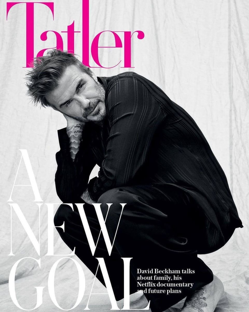 David Beckham crouching in a black suit on the cover of Tatler